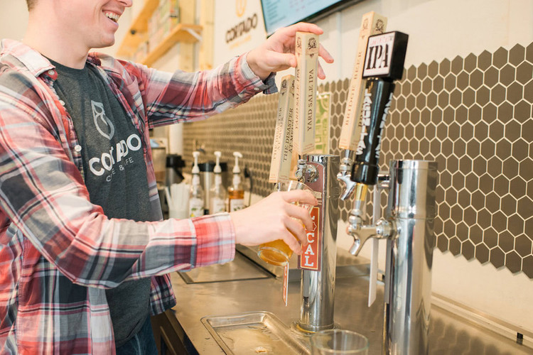 Man pouring craft beer into a pint glass